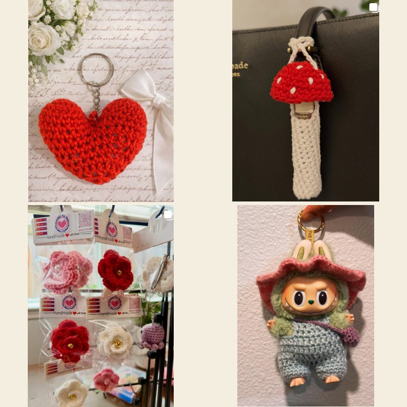 Completed handmade crochet products: a heart keychain, a mushroom keychain, flower pins, and a crochet doll